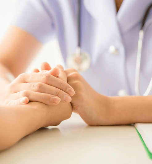 doctor holding hand of patient